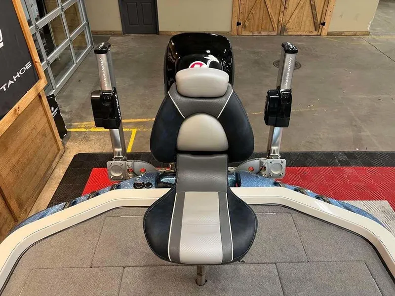 Slide: The Image of 2015 Ranger Z520C boat seat with dual power poles in a garage setting. - 8