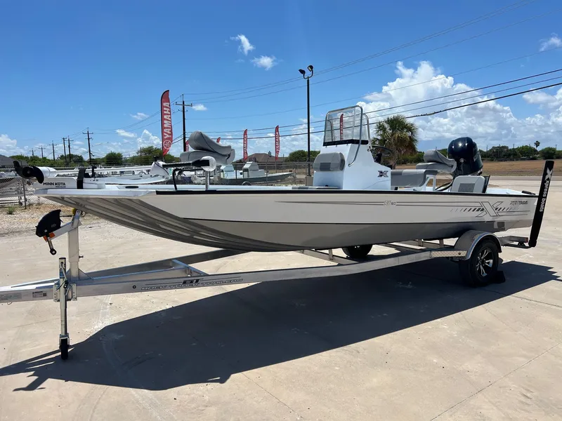 Slide: The Image of 2025 Xpress SW20B boat on trailer under clear blue sky. - 38