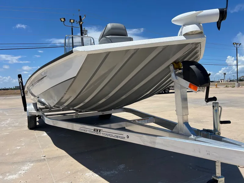 Slide: The Image of 2025 Xpress SW20B boat on trailer under clear blue sky. - 41