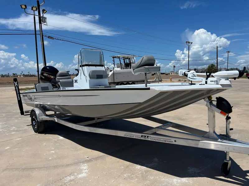 Slide: The Image of 2025 Xpress SW20B boat on trailer under clear blue sky. - 42