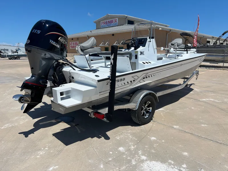 Slide: The Image of 2025 Xpress SW20B boat with Yamaha 115 engine on trailer, parked outdoors. - 44
