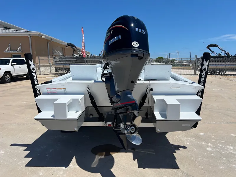 Slide: The Image of 2025 Xpress SW20B boat with Yamaha 115 engine, parked outdoors. - 45