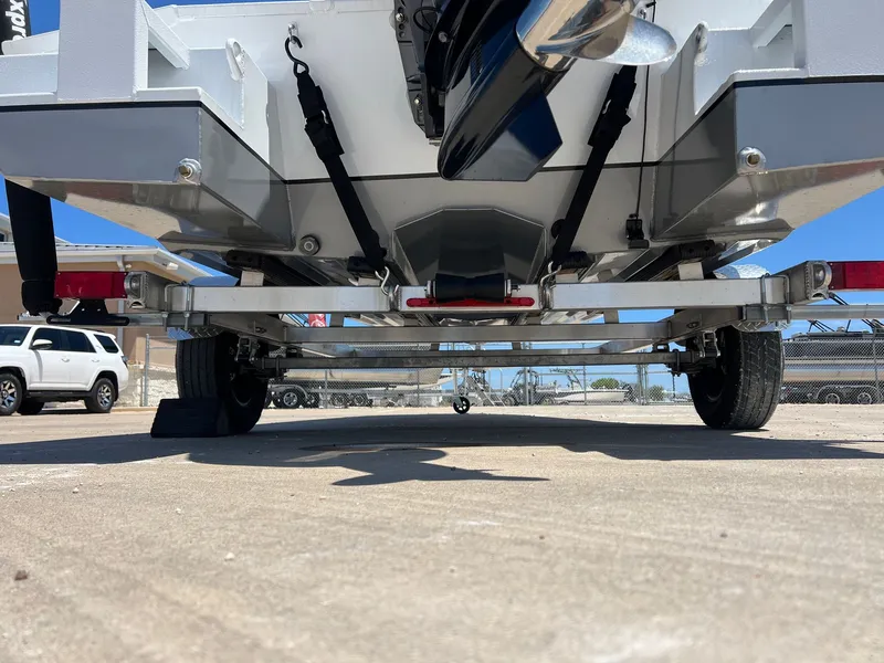 Slide: The Image of 2025 Xpress SW20B boat on trailer, viewed from rear, showcasing undercarriage and wheels. - 46