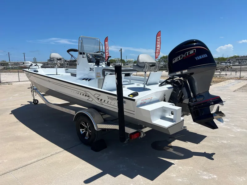Slide: The Image of 2025 Xpress SW20B boat with Yamaha engine on trailer, parked outdoors. - 47