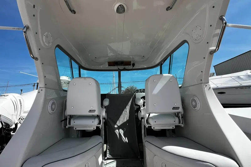 Slide: The Image of Interior view of 2013 Protector Targa 30 boat with two white seats. - 14