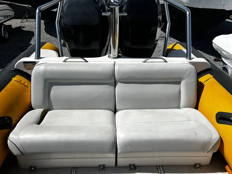 Slide: The Image of 2013 Protector Targa 30 boat with white cushioned seating and yellow accents. - 15