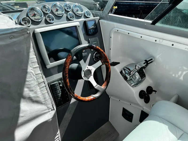 Slide: The Image of Cockpit of 2013 Protector Targa 30 boat with steering wheel and control panel. - 19