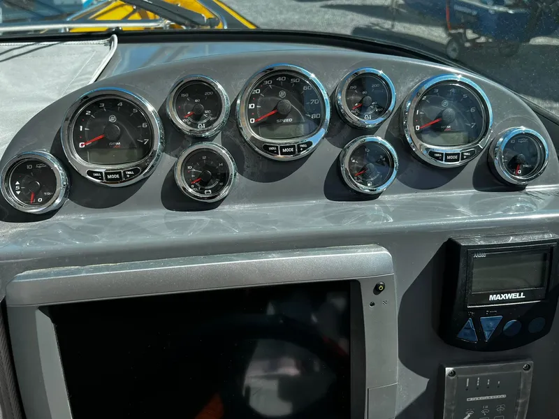 Slide: The Image of Dashboard of a 2013 Protector Targa 30 boat with multiple gauges and controls. - 20