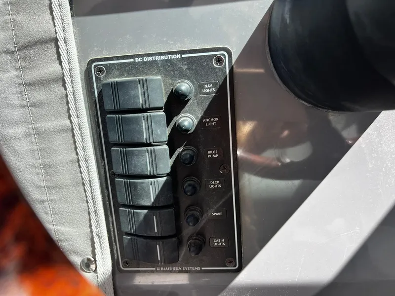 Slide: The Image of Control panel on a 2013 Protector Targa 30 boat, featuring DC distribution switches. - 24