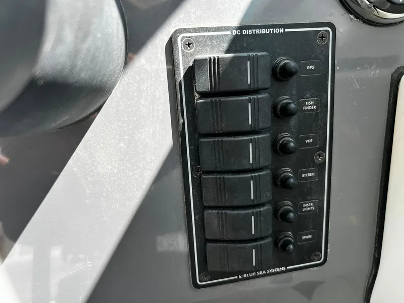 Slide: The Image of Control panel on a 2013 Protector Targa 30 boat, featuring labeled switches. - 25
