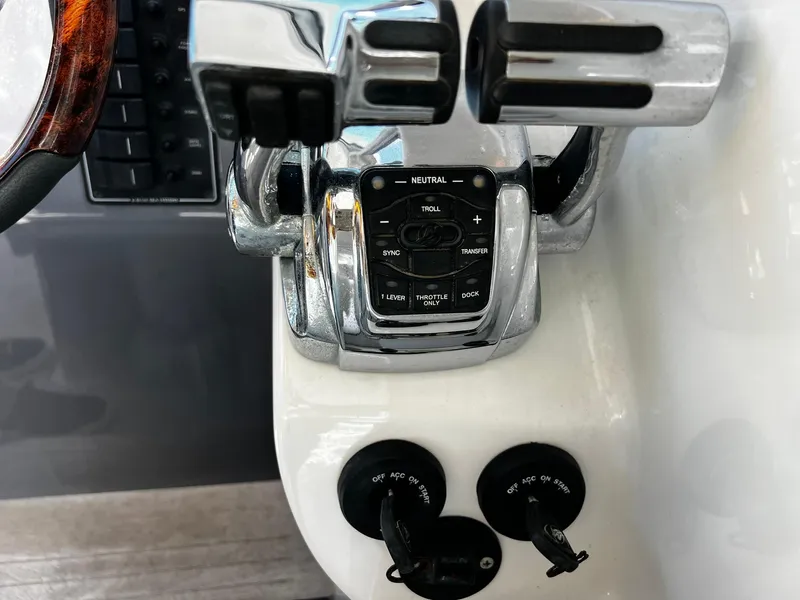Slide: The Image of Control panel of a 2013 Protector Targa 30 boat with throttle levers and ignition switches. - 27