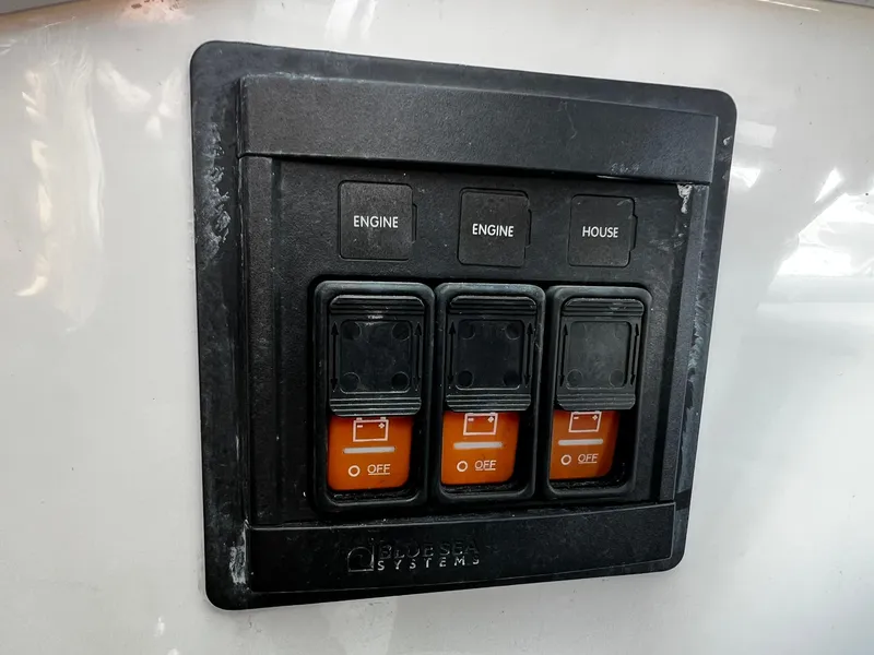 Slide: The Image of Control panel on a 2013 Protector Targa 30 boat with labeled switches. - 29