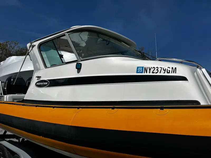 Slide: The Image of 2013 Protector Targa 30 boat with yellow hull and registration NY2379GM. - 3