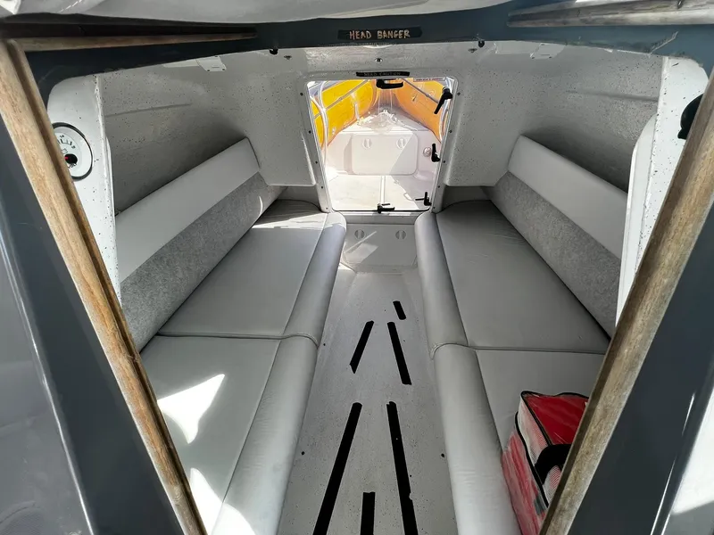 Slide: The Image of Interior of 2013 Protector Targa 30 boat, featuring cushioned seating and sleek design. - 34