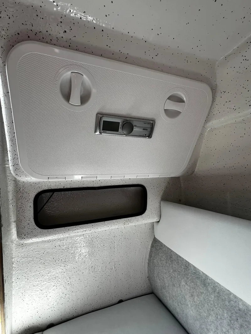 Slide: The Image of Interior cabin of 2013 Protector Targa 30 boat, featuring storage compartment and control panel. - 39