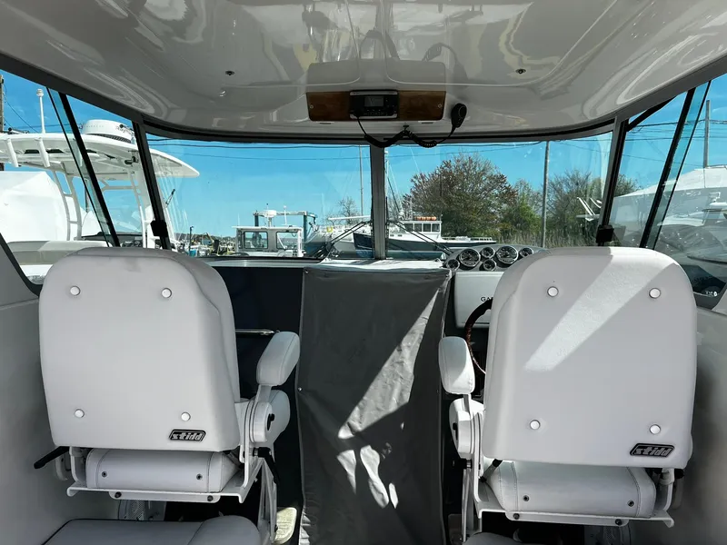 Slide: The Image of Interior view of a 2013 Protector Targa 30 boat with two white seats. - 40