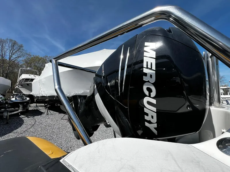 Slide: The Image of 2013 Protector Targa 30 with Mercury outboard engine, parked outdoors under clear blue sky. - 7