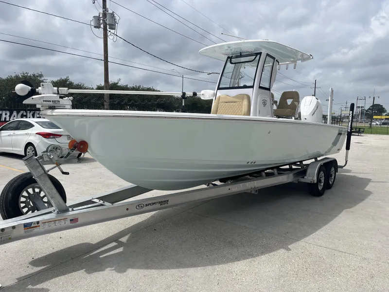 Slide: The Image of 2023 Sportsman Masters 267 boat on trailer in parking lot, cloudy sky background. - 10