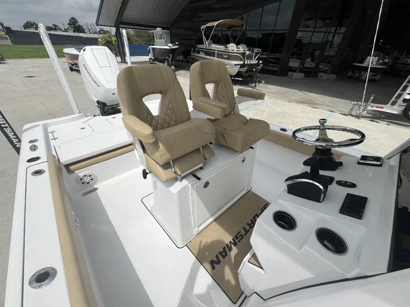 Slide: The Image of 2023 Sportsman Masters 267 boat interior with dual beige captain seats and steering console. - 14
