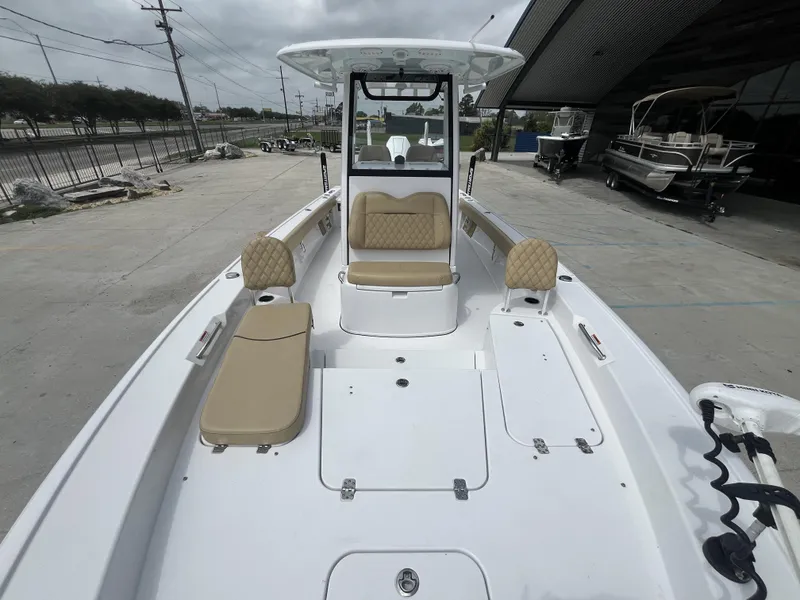Slide: The Image of 2023 Sportsman Masters 267 boat with beige seating, docked outdoors. - 15