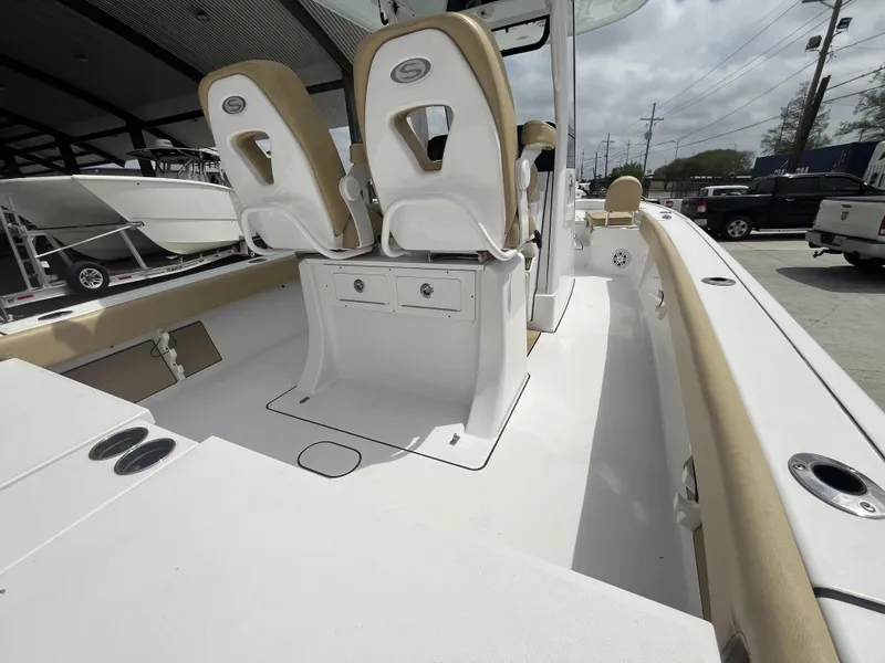 Slide: The Image of 2023 Sportsman Masters 267 boat interior with dual seats and storage compartments. - 17