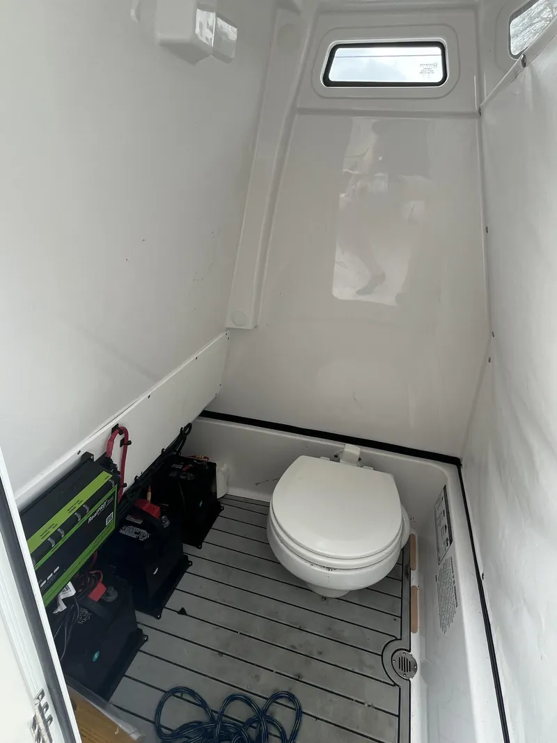 Slide: The Image of Interior of a 2023 Sportsman Masters 267 boat with a compact marine toilet. - 20