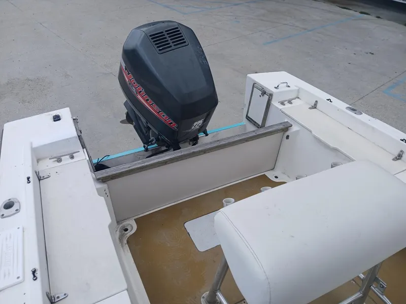 Slide: The Image of 1980 Mako 213 boat with outboard motor, white interior, and seating. - 11