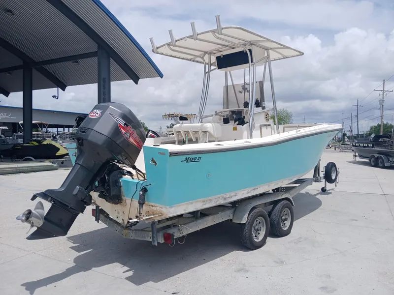 Slide: The Image of 1980 Mako 213 boat on trailer with outboard motor, parked outdoors. - 5