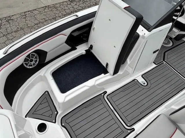 Slide: The Image of 2018 Yamaha Boats 212X interior with open storage compartment and sleek design. - 11