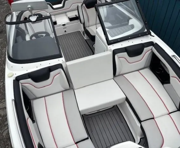 Slide: The Image of 2018 Yamaha Boats 212X interior with white and black seating, red accents, and open windshield. - 13