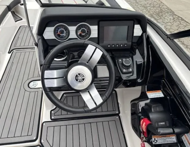 Slide: The Image of Steering console of 2018 Yamaha Boats 212X with modern controls and dashboard. - 20