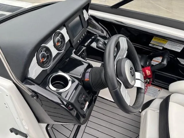 Slide: The Image of 2018 Yamaha Boats 212X dashboard with steering wheel and gauges. - 21