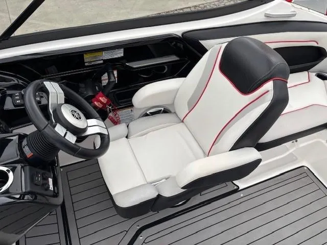 Slide: The Image of 2018 Yamaha Boats 212X interior with sleek steering and comfortable seating. - 24