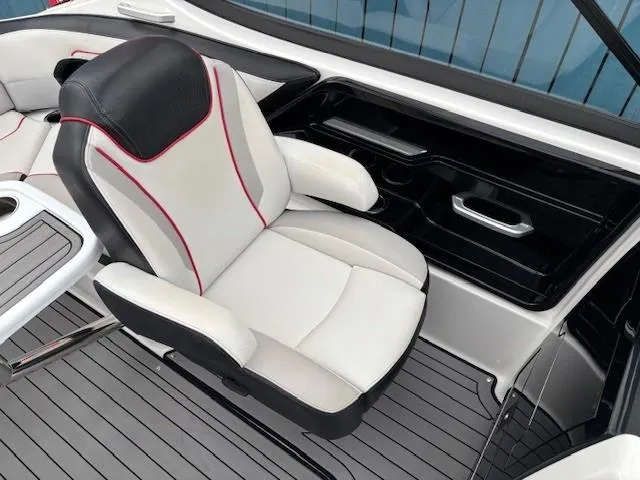 Slide: The Image of 2018 Yamaha Boats 212X interior with sleek white and black seating, red accents, and modern design. - 26
