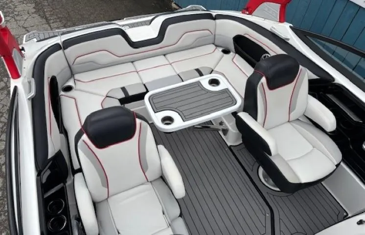 Slide: The Image of 2018 Yamaha Boats 212X interior with sleek seating and a central table. - 27