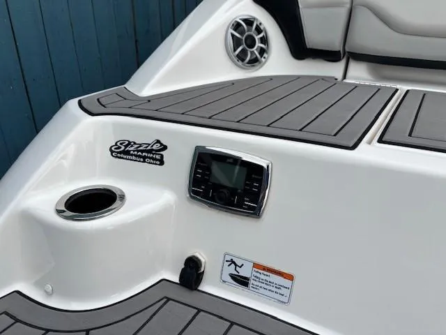 Slide: The Image of 2018 Yamaha Boats 212X interior with speaker, control panel, and cup holder. - 37