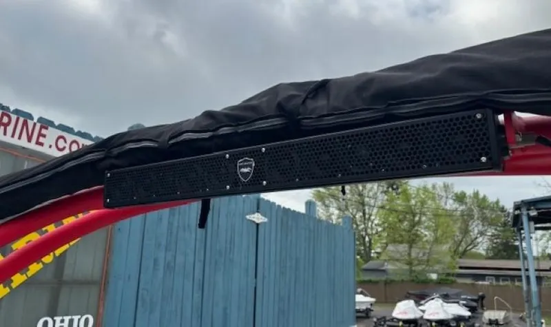 Slide: The Image of 2018 Yamaha Boats 212X with mounted speaker on red frame, outdoor setting. - 40