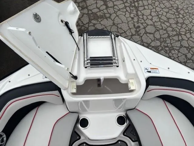 Slide: The Image of 2018 Yamaha Boats 212X bow with open storage compartment and ladder. - 8