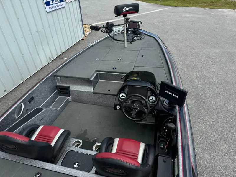 Slide: The Image of 2013 Blazer 625 boat interior with steering wheel, seats, and control panel. - 13