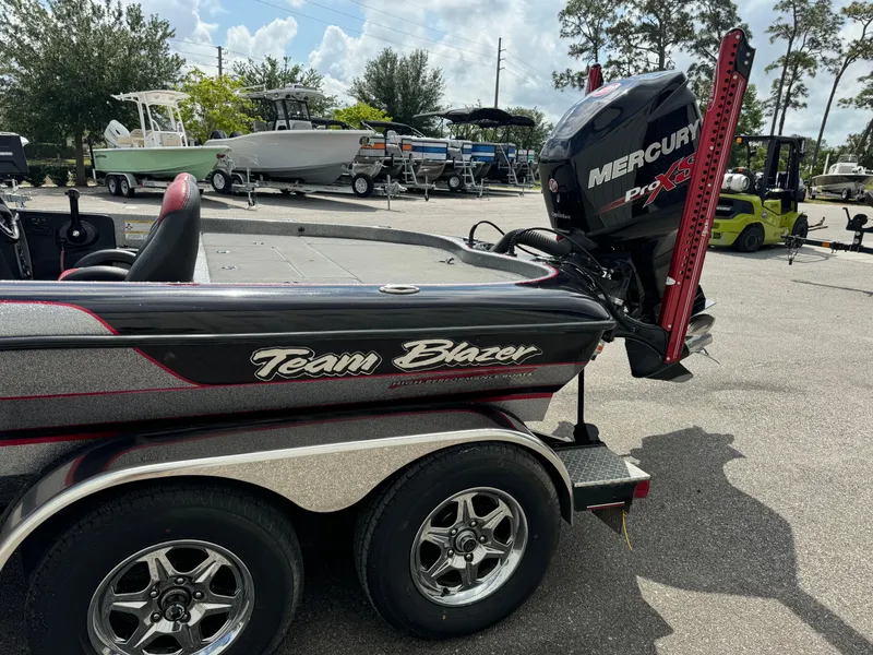 Slide: The Image of 2013 Blazer 625 boat with Mercury Pro XS engine in a parking lot. - 18