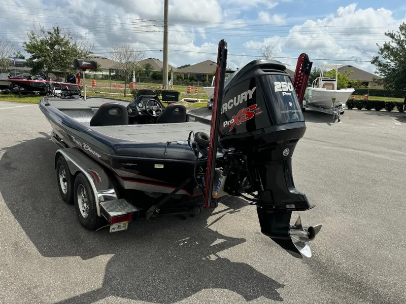 Slide: The Image of 2013 Blazer 625 boat with Mercury 250 Pro XS engine in a parking lot. - 19
