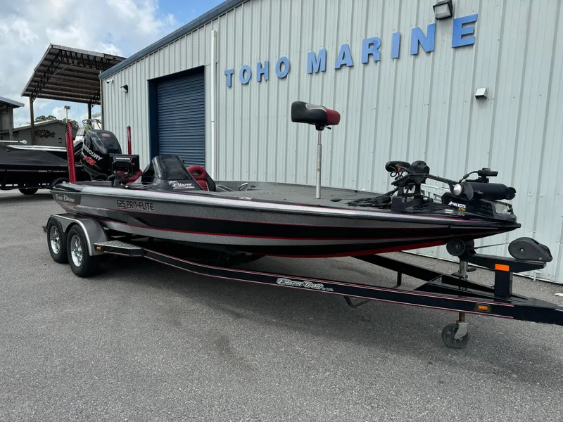 Slide: The Image of 2013 Blazer 625 boat at Toho Marine dealership, parked on a trailer. - 2