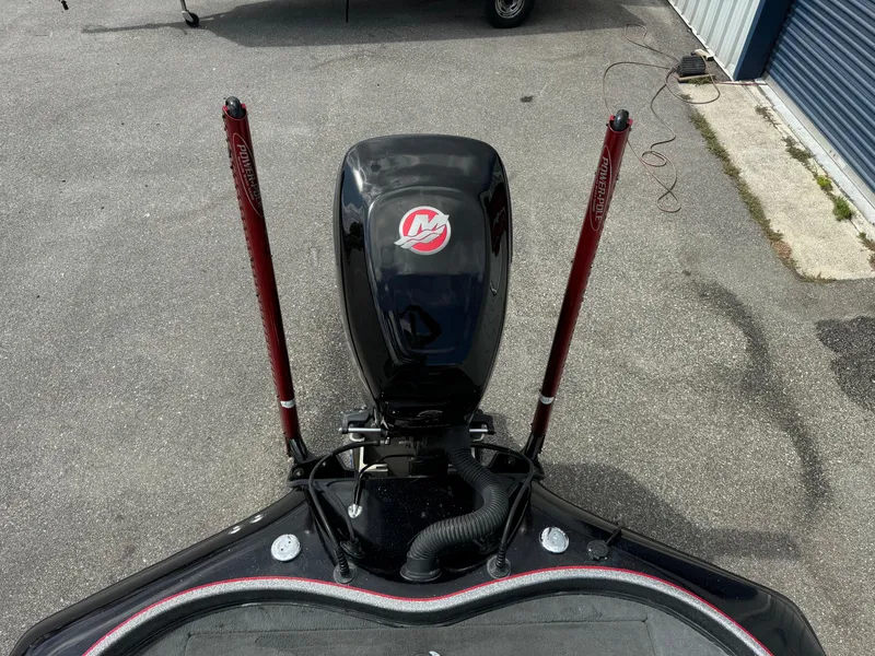 Slide: The Image of 2013 Blazer 625 boat with outboard motor and dual power poles in a parking area. - 22