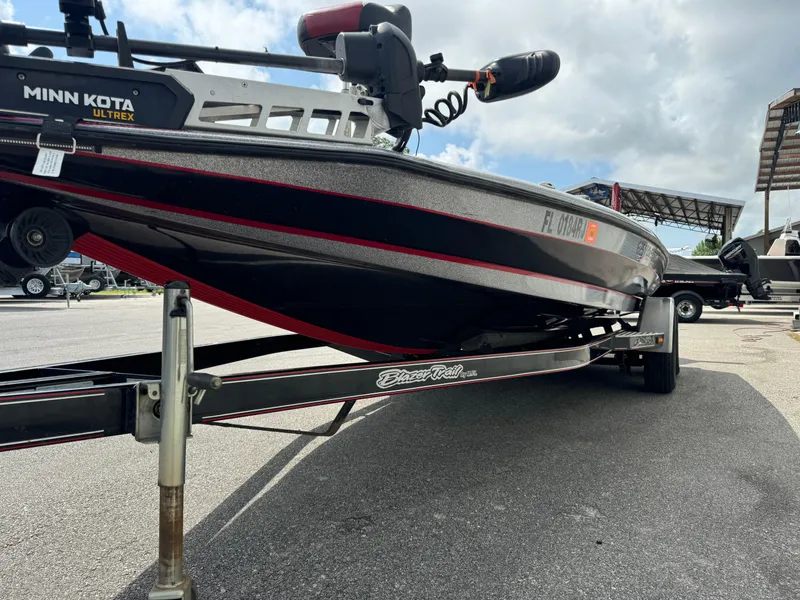 Slide: The Image of 2013 Blazer 625 boat on trailer with Minn Kota Ultrex motor, parked outdoors. - 4