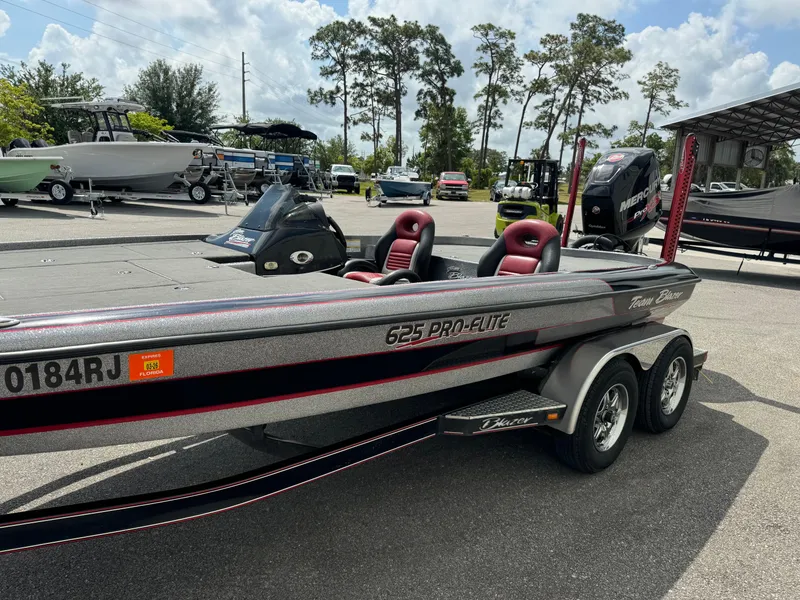 Slide: The Image of Blazer 625 Pro-Elite boat, 2013 model, parked outdoors with red seats and dual axles. - 5