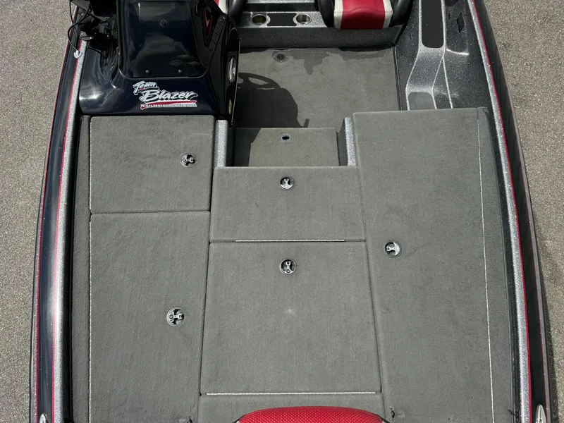 Slide: The Image of 2013 Blazer 625 boat interior with gray carpet and storage compartments. - 8