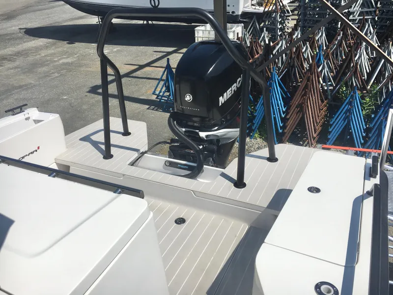 Slide: The Image of 2019 Axopar 28 CABIN boat with Mercury outboard engine, docked on a sunny day. - 11