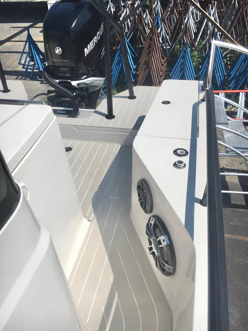 Slide: The Image of 2019 Axopar 28 CABIN boat deck with Mercury engine and speakers. - 12