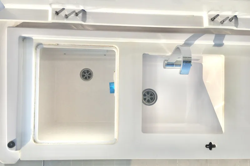 Slide: The Image of Two white sinks on a 2019 Axopar 28 CABIN boat. - 15