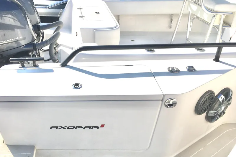 Slide: The Image of 2019 Axopar 28 CABIN boat deck with motor and seating area. - 16